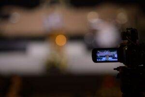 A behind-the-scenes sports and entertainment production scene showing creators, athletes, or production teams capturing authentic moments. The image represents how real access, human storytelling, and authentic experiences are becoming the most valuable marketing assets in the AI era.