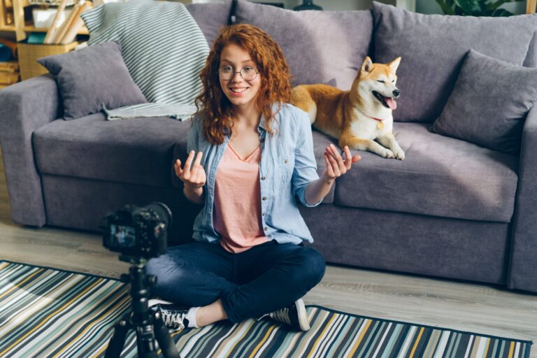 Professional content creation studio setup featuring a smartphone on a tripod with an RGB ring light and a green screen background.