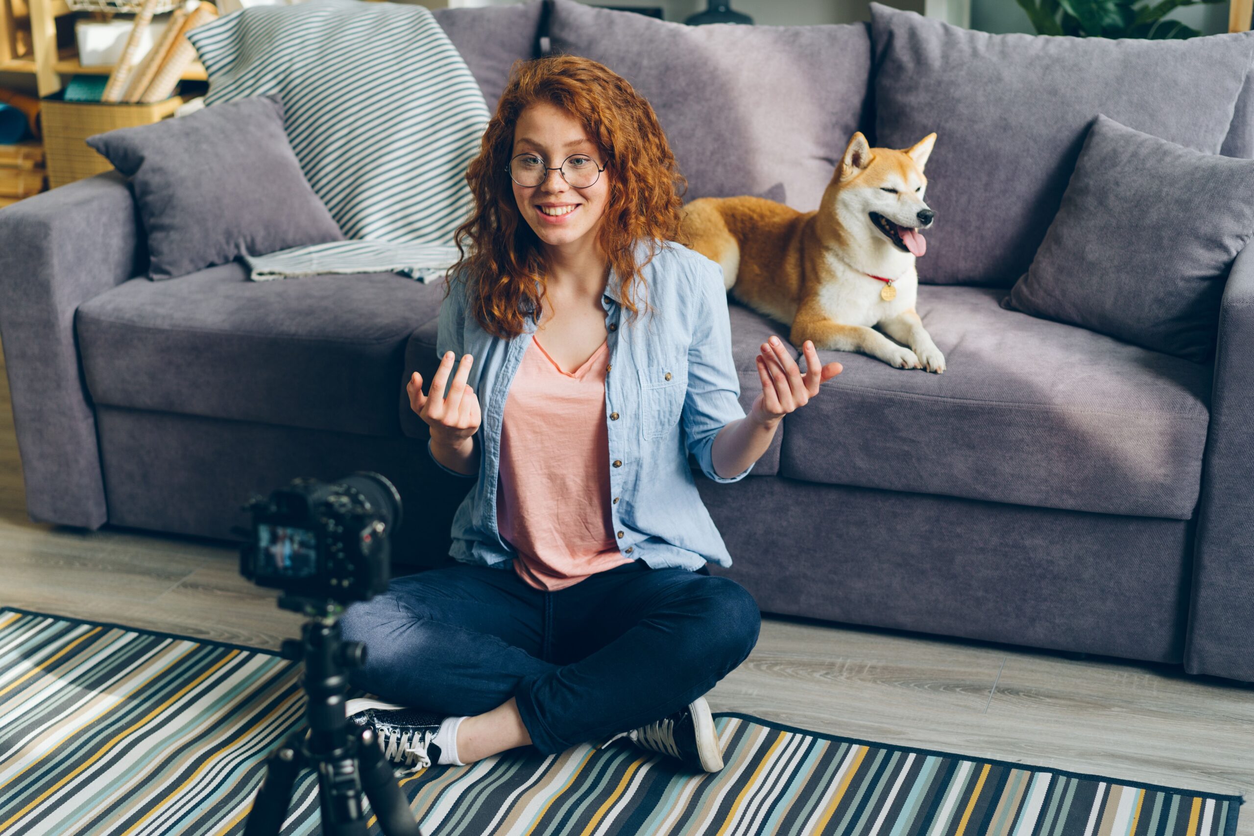Professional content creation studio setup featuring a smartphone on a tripod with an RGB ring light and a green screen background.