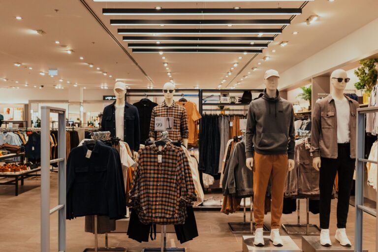 Chic, minimalist boutique clothing store interior with modern apparel displays, showcasing retail marketing and brand development solutions.